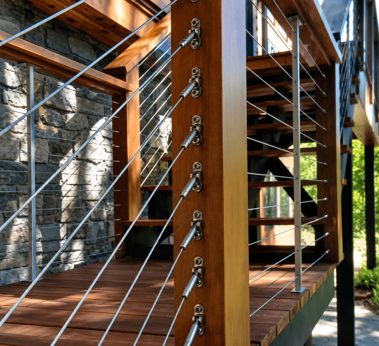 Close-up of stainless cable tensioners on a wood post of a deck railing