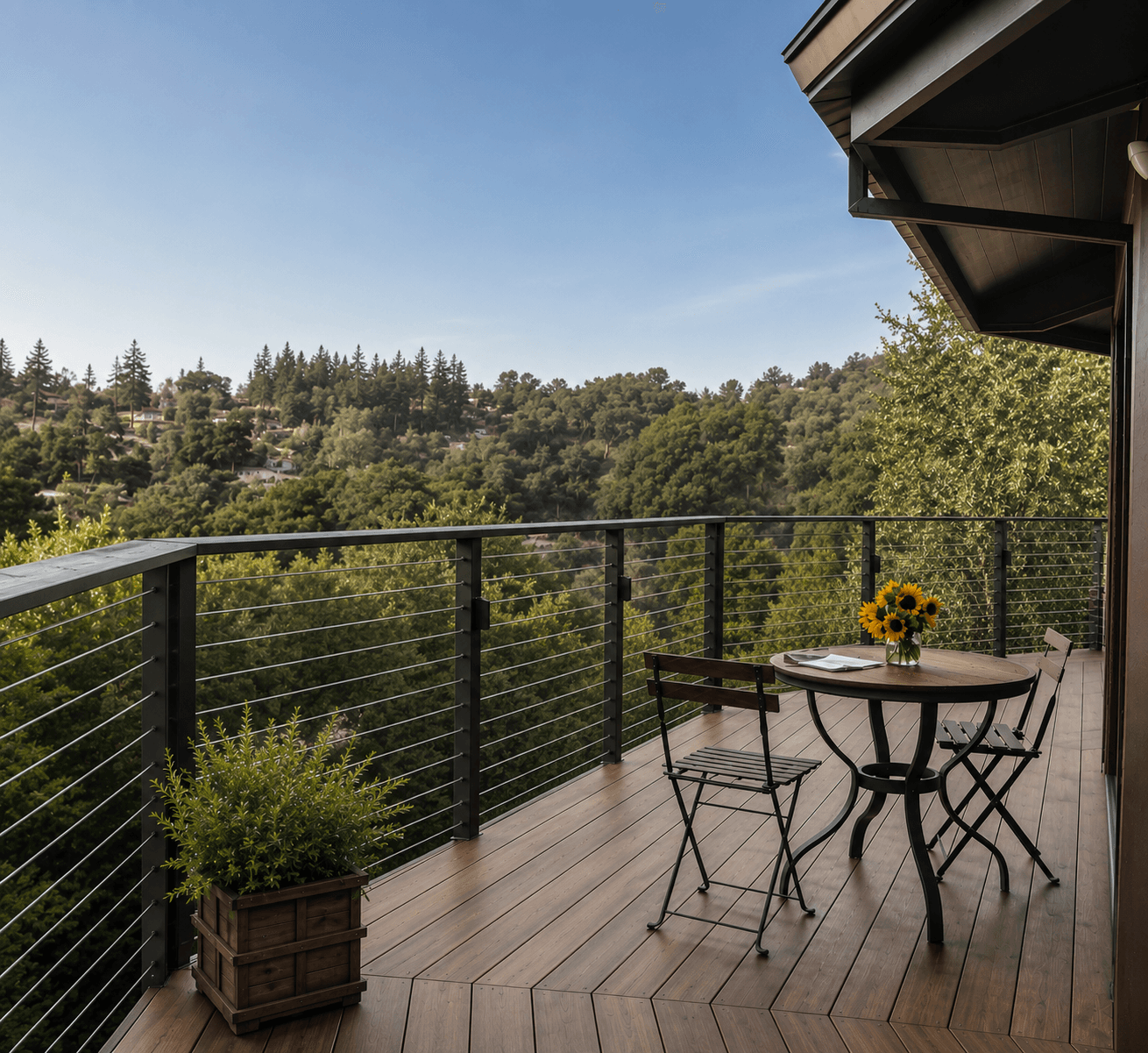 Horizontal cable railing on a composite deck balcony overlooking a wooded hillside