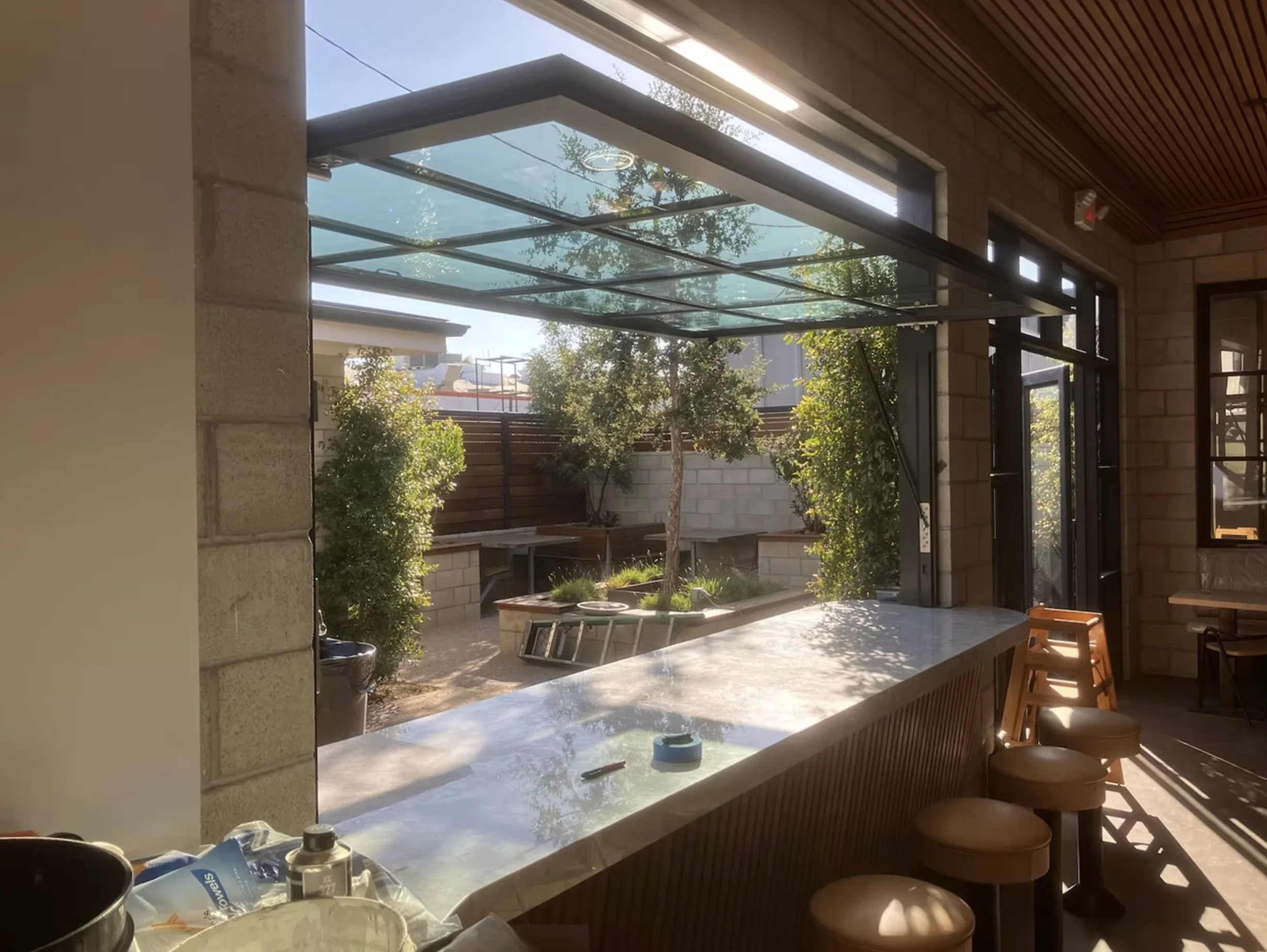 Gas strut glass window opened above an indoor outdoor bar counter